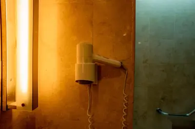 a blow dryer on the wall of a bathroom at Kuta Paradiso Hotel in Kuta