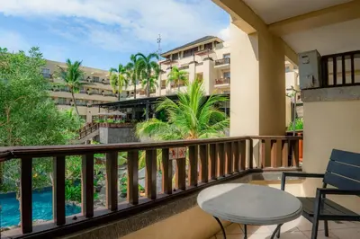 a balcony with a table and a view of the ocean at Kuta Paradiso Hotel in Kuta
