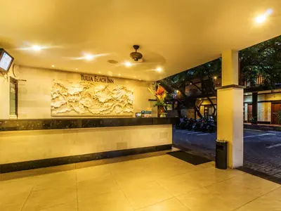a lobby of a hotel with a sign on the wall at Yulia Beach Inn Kuta in Kuta