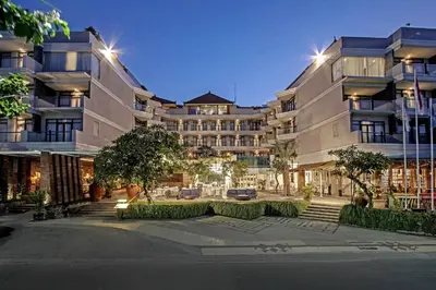 a large building with a courtyard in front of it at Wyndham Garden Kuta Beach Bali in Kuta