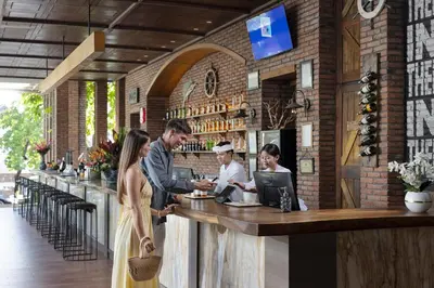 a group of people standing at a bar at Wyndham Garden Kuta Beach Bali in Kuta