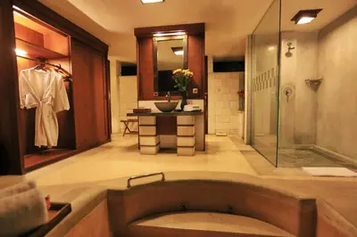 a large bathroom with a tub and a shower at The Sanyas Suite Bali in Seminyak