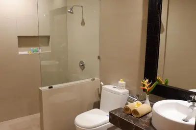 a bathroom with a toilet and a sink and a shower at Seminyak Paradiso Hotel in Seminyak