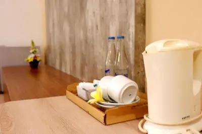 a table with a blender and two glass bottles at Seminyak Paradiso Hotel in Seminyak