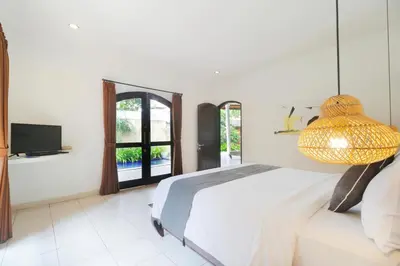 a bedroom with a bed with a lamp on it at Singgah Villas Seminyak in Seminyak