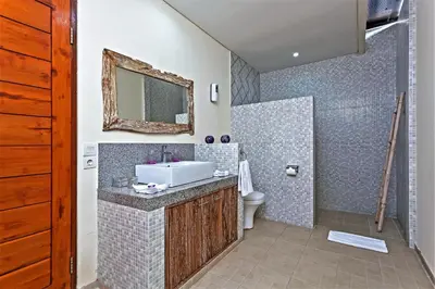 a bathroom with a sink and a toilet at Rumah Indah Villa in Seminyak