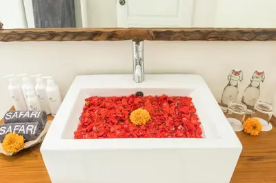 a white sink with red peppers in it at Villa Safari in Seminyak