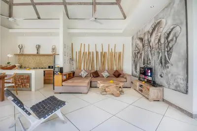 a living room with a couch and a kitchen at Villa Safari in Seminyak
