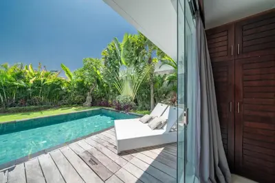a villa with a swimming pool and a patio at Villa Tira - Elegant 3BR in Central Seminyak in Seminyak