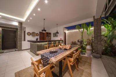 a dining room with a table and some plants at Villa Tira - Elegant 3BR in Central Seminyak in Seminyak