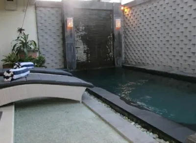 a swimming pool in a building with a swimming pool at Sun Shoot Villas Seminyak in Seminyak