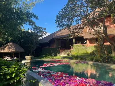 a pool of flowers in front of a house at Villa Bella Bali - Authentic Balinese Luxury Villa with Tropical Elegance - Nanny and Cook in Canggu