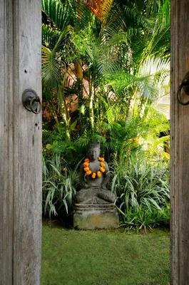 a vase with oranges on it in a garden at Villa Bella Bali - Authentic Balinese Luxury Villa with Tropical Elegance - Nanny and Cook in Canggu