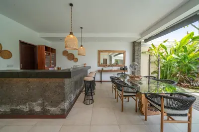 an open kitchen and dining room with a glass table and chairs at Villa Bima - 3 Bedroom Villa in Seminyak in Seminyak