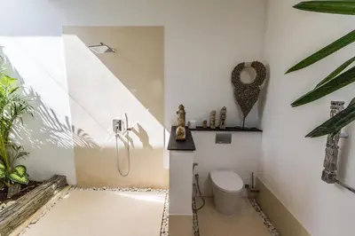 a bathroom with a toilet and a shower at Villa Juna - Beautiful 3 Bedroom in Seminyak in Seminyak