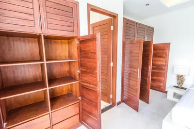 a room with wooden shelves and wooden doors at Villa Juna - Beautiful 3 Bedroom in Seminyak in Seminyak