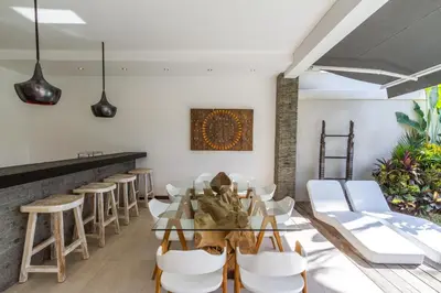 a restaurant with a glass table and white chairs at Villa Nala - Amazing 3-Bedroom in Seminyak in Seminyak