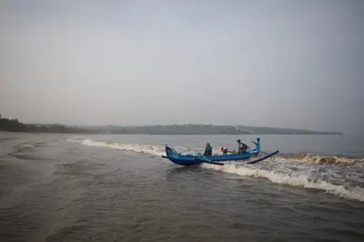 a group of people in a blue boat on the beach at Ahimsa Beach in Jimbaran