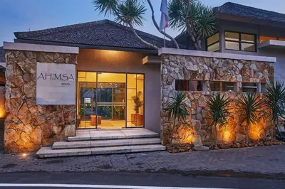 a building with a sign on the front of it at Ahimsa Beach in Jimbaran