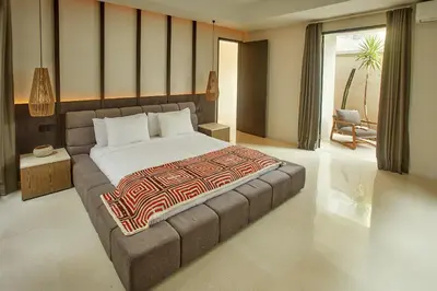a bedroom with a large bed in a room at Ahimsa Beach in Jimbaran