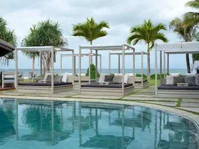 a swimming pool with a view of the ocean at Sadara Resort in Nusa Dua