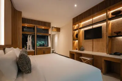 a bedroom with a large bed and a television at Sadara Resort in Nusa Dua