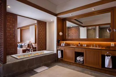 a bathroom with a tub and a large mirror at Sadara Resort in Nusa Dua