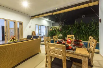 a dining room with a table and chairs at Castro Villa in Seminyak