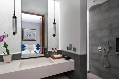 a bathroom with a sink and a mirror at Amarin Seminyak in Seminyak