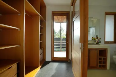 a bathroom with a sink and a toilet and a door at Villa the Hotman Paris I Seminyak in Seminyak