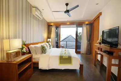 a bedroom with a large bed and a television at Villa the Hotman Paris I Seminyak in Seminyak