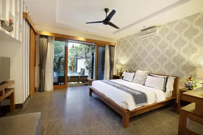 a bedroom with a bed and a ceiling fan at Villa the Hotman Paris I Seminyak in Seminyak