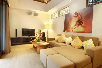 a living room with a couch and a flat screen tv at Villa The Hotman Paris II Seminyak in Seminyak