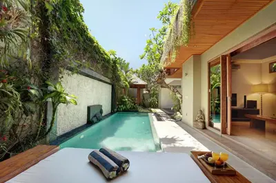 an infinity pool in the backyard of a house at Villa The Hotman Paris II Seminyak in Seminyak