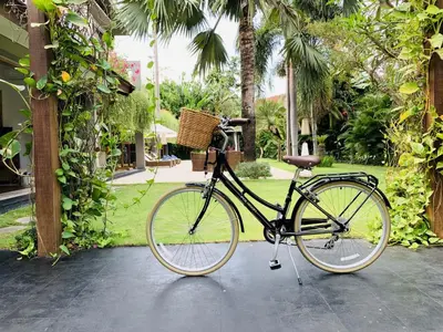 a bike with a basket parked in a courtyard at Kamehameha Luxury Villa in Seminyak