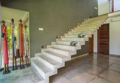 a staircase in a room with skis on the wall at Kamehameha Luxury Villa in Seminyak