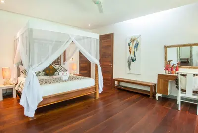 a bedroom with a bed with a canopy at Kamehameha Luxury Villa in Seminyak
