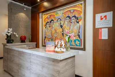 a large painting of a group of women on a wall at Swiss-Belcourt Sunset in Seminyak