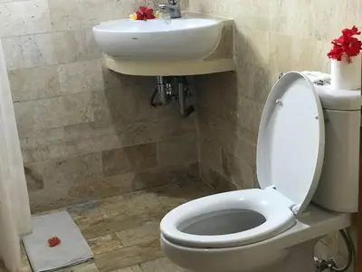 a bathroom with a toilet and a sink at Melasti Beach Resort & Spa Legian in Legian