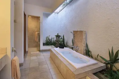 a large bathroom with a tub and a shower at The Lagoon Bali Pool Hotel and Suites in Legian