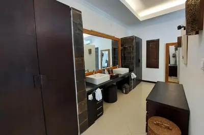 a bathroom with two sinks and a large mirror at The Maya Seminyak Villas in Seminyak