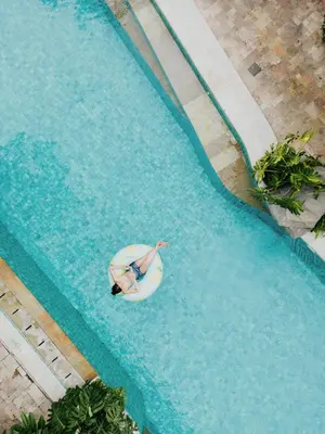 a person swimming in a swimming pool in a swimming pool at Baleka Resort & Spa in Legian