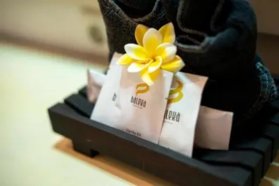 a yellow flower sitting on top of a black shelf at Baleka Resort & Spa in Legian