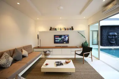 a living room with a couch and a tv at Villa Aditi, Sitara Villa Group in Seminyak