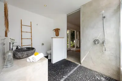 a bathroom with a shower and a sink at Renovated Villa Aksara Oberoi, 700m to Beach in Seminyak