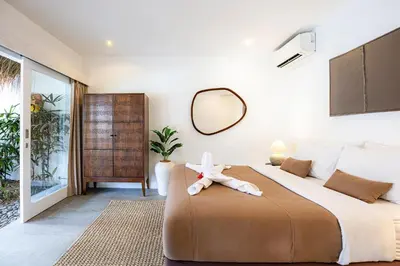 a bedroom with a large bed and a mirror at Renovated Villa Gladak, 200m to Oberoi Seminyak in Seminyak