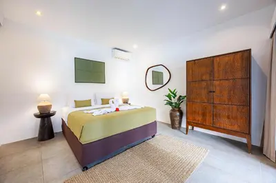 a bedroom with a large bed and a dresser at Renovated Villa Gladak, 200m to Oberoi Seminyak in Seminyak