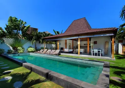 a villa with a swimming pool and a house at Villa Tinn Tamm by Optimum Bali Villas in Seminyak