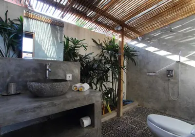 a bathroom with a sink and a toilet and plants at Villa Tinn Tamm by Optimum Bali Villas in Seminyak