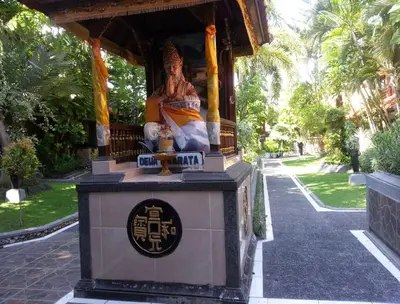 a statue of a woman sitting on top of a building at Dewa Bharata Bungalows Legian in Legian